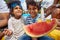 Afro-American Parents and Kids Enjoy a Poolside Watermelon Feast