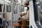 Afro-American passenger man stand in subway train, wear face medical mask to protect yourself from flu virus, covid-19, using