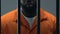 Afro-American prisoner in handcuffs feeling sorrow about made crime, guilty