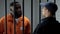 Afro-american prisoner making arrangement with prison guard, corruption in jail