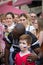 Afro american sport fans support russian boy with russian flag on the cheek
