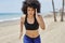 Afro american sportswoman jogging on beach