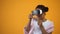 Afro-american woman in virtual reality glasses playing games, motion controllers