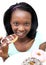 Afro-American young woman eating a chocolate donut