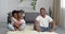 Afro american young woman mom and black man dad sit barefoot on living room floor in cozy home meditate little cute