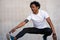 Afro athletic man stretching arms before exercise.