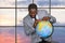 Afro businessman touching globe.