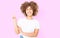 Afro curly hair. Happy young african american girl showing victory sign isolated on pink background. Copy space. Template