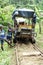 Afro-Ecuadorian boy in front of a `ghost train` in the jungle