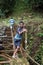 Afro-Ecuadorian boy standing on a railroad bridge in the jungle