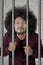 Afro man looks drunk in the jail
