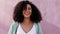 Afro, mexican woman or fashion fun on pink wall background, city building and mockup marketing design for advertising