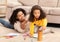 Afro Mother And Daughter Drawing Spending Time Together At Home