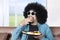 Afro person eating donuts