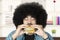 Afro person enjoying burger