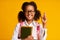 Afro Schoolgirl Keeping Fingers Crossed For Luck Over Yellow Background