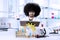 Afro scientist reading a book in laboratory