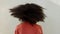 Afro woman shaking natural hair curls with white wall background and mockup or copy space. Funky, carefree and