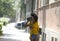 Afro young lady with sunglasses.She walks on the street and holding a manual camera and shoots