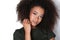 Afroamercian young woman in dark green dress on white background.