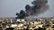 Aftermath of Israeli Air Strikes: Smoke Rises Over the City - Extra Large