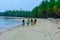 An afternoon on an african island. Four fisher women walking on a white sand beach