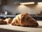 Afternoon Delight: Croissant Takes Center in a Cozy, Sunlit Kitchen Scene