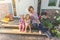 Afternoon mom and two daughters on the threshold of the house