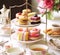 Afternoon tea, English tradition and restaurant service, tea cups, cakes, scones, sanwiches and desserts, holiday table decor and