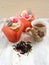 Afternoon tea with flowers cupcakes in vintage teacup and petals brew on shabby table colors of spring