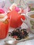 Afternoon tea with roses cupcakes, vintage teacup, old silver spoon and petals brew on white shabby table