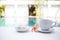 Afternoon tea time at pool side, white tea cup with thai sweet on white table over blurred swimming pool background