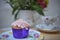 Afternoon tea with vintage floral crockery and a cupcake