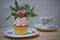Afternoon tea with vintage floral crockery and a cupcake