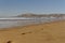 Agadir, Morocco.Feb.3,2019:Beach with tourist walking and Moroccan motto on the mountain. Writing on the hillside