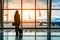 Against the backdrop of an airplane and bright departure gate, a businesswoman stands confidently. Ready to embark on her business