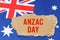 Against the background of the flag of Australia lies cardboard with the inscription - Anzac Day