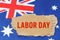 Against the background of the flag of Australia lies cardboard with the inscription - Labor Day