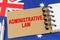Against the background of the flag of Australia lies a notebook with the inscription - ADMINISTRATIVE LAW