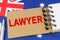 Against the background of the flag of Australia lies a notebook with the inscription - LAWYER