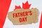 Against the background of the flag of Canada lies cardboard with the inscription - Fathers Day