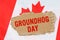 Against the background of the flag of Canada lies cardboard with the inscription - Groundhog Day