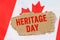 Against the background of the flag of Canada lies cardboard with the inscription - Heritage Day