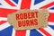 Against the background of the flag of Great Britain lies cardboard with the inscription - Robert Burns