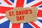 Against the background of the flag of Great Britain lies cardboard with the inscription - St. Davids Day