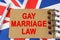 Against the background of the flag of Great Britain lies a notebook with the inscription - GAY MARRIAGE LAW