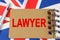 Against the background of the flag of Great Britain lies a notebook with the inscription - LAWYER