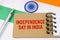 Against the background of the flag of India lies cardboard with the inscription - Independence Day in India