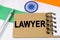 Against the background of the flag of India lies a notebook with the inscription - LAWYER