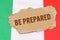Against the background of the flag of Italy lies cardboard with the inscription - Be Prepared